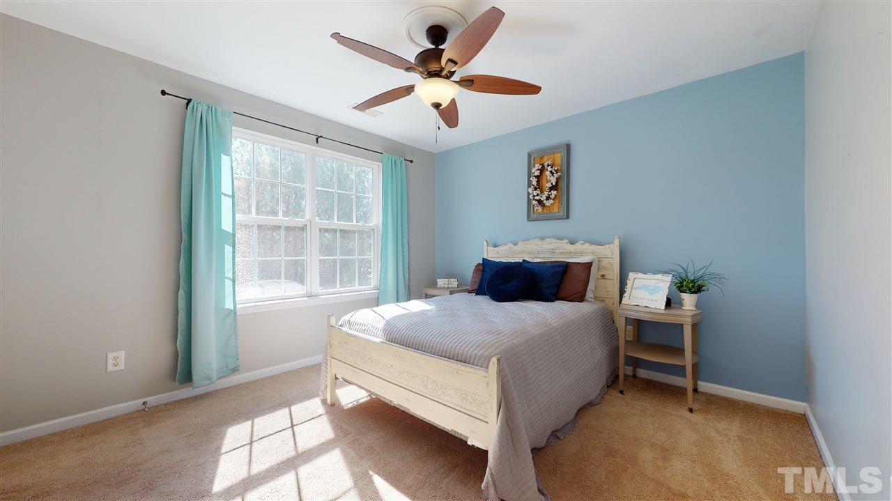 7621 Winners Edge Street Raleigh, NC 27617 - Photo 20 of 30 a bedroom with a bed and window