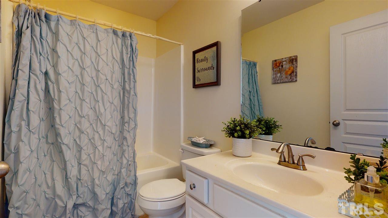 7621 Winners Edge Street Raleigh, NC 27617 - Photo 21 of 30 a bathroom with a sink toilet and shower