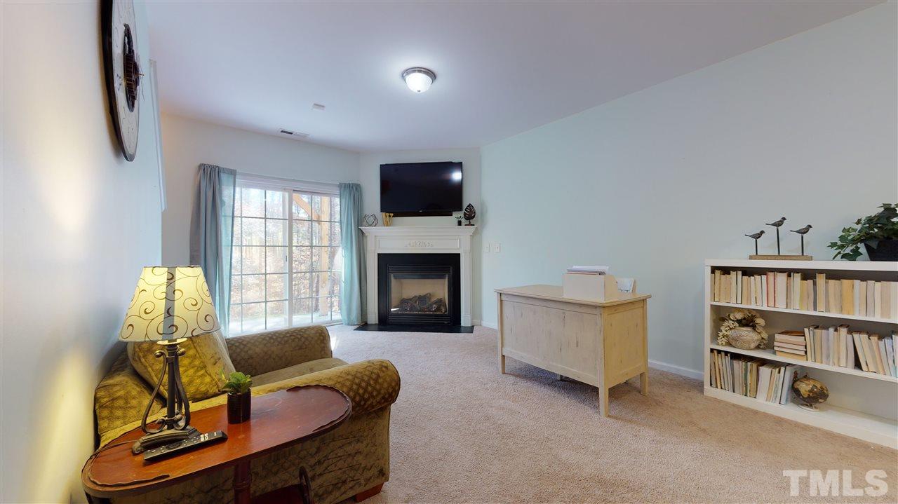 7621 Winners Edge Street Raleigh, NC 27617 - Photo 23 of 30 a living room with furniture and a flat screen tv