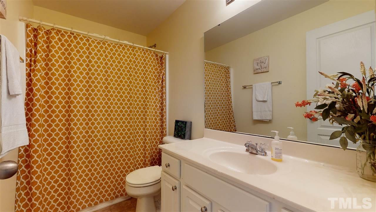 7621 Winners Edge Street Raleigh, NC 27617 - Photo 24 of 30 a bathroom with a sink toilet and mirror
