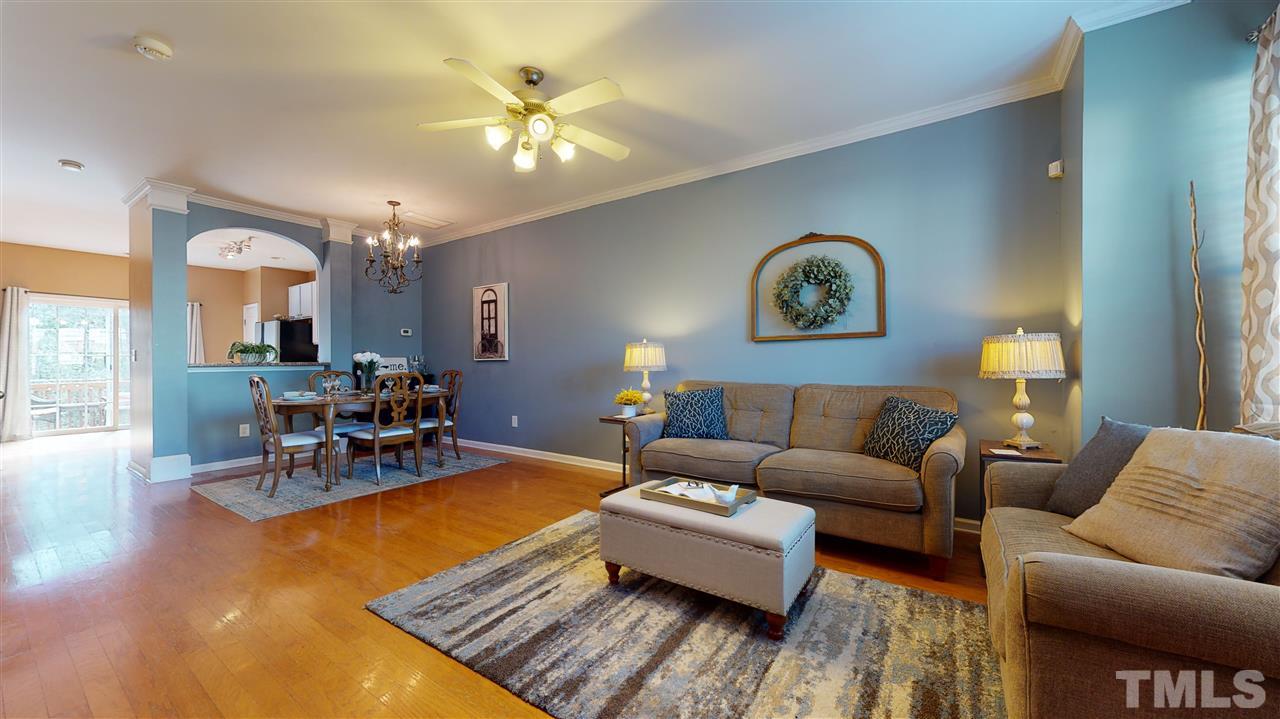 7621 Winners Edge Street Raleigh, NC 27617 - Photo 4 of 30 a living room with furniture and a chandelier