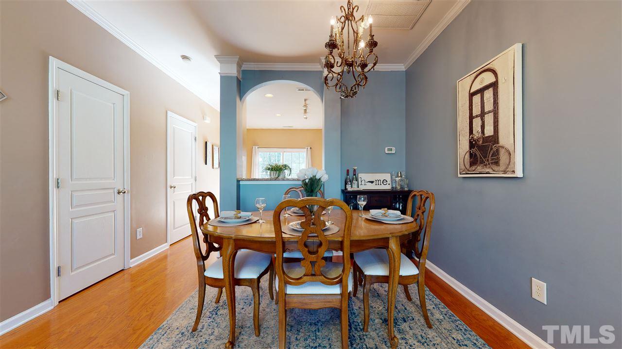 7621 Winners Edge Street Raleigh, NC 27617 - Photo 6 of 30 a view of a dining room with furniture and chandelier