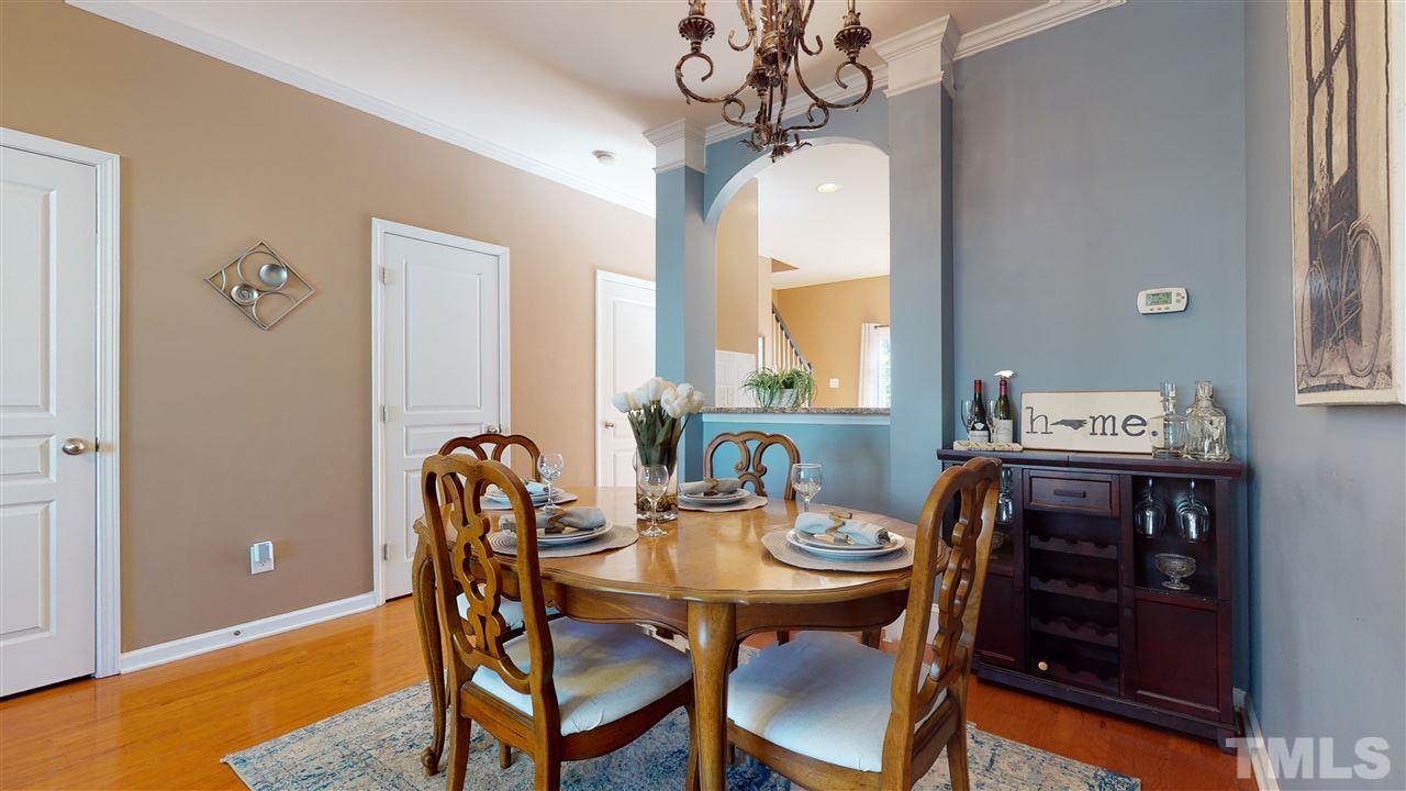 7621 Winners Edge Street Raleigh, NC 27617 - Photo 7 of 30 a view of a dining room with furniture window and wooden floor