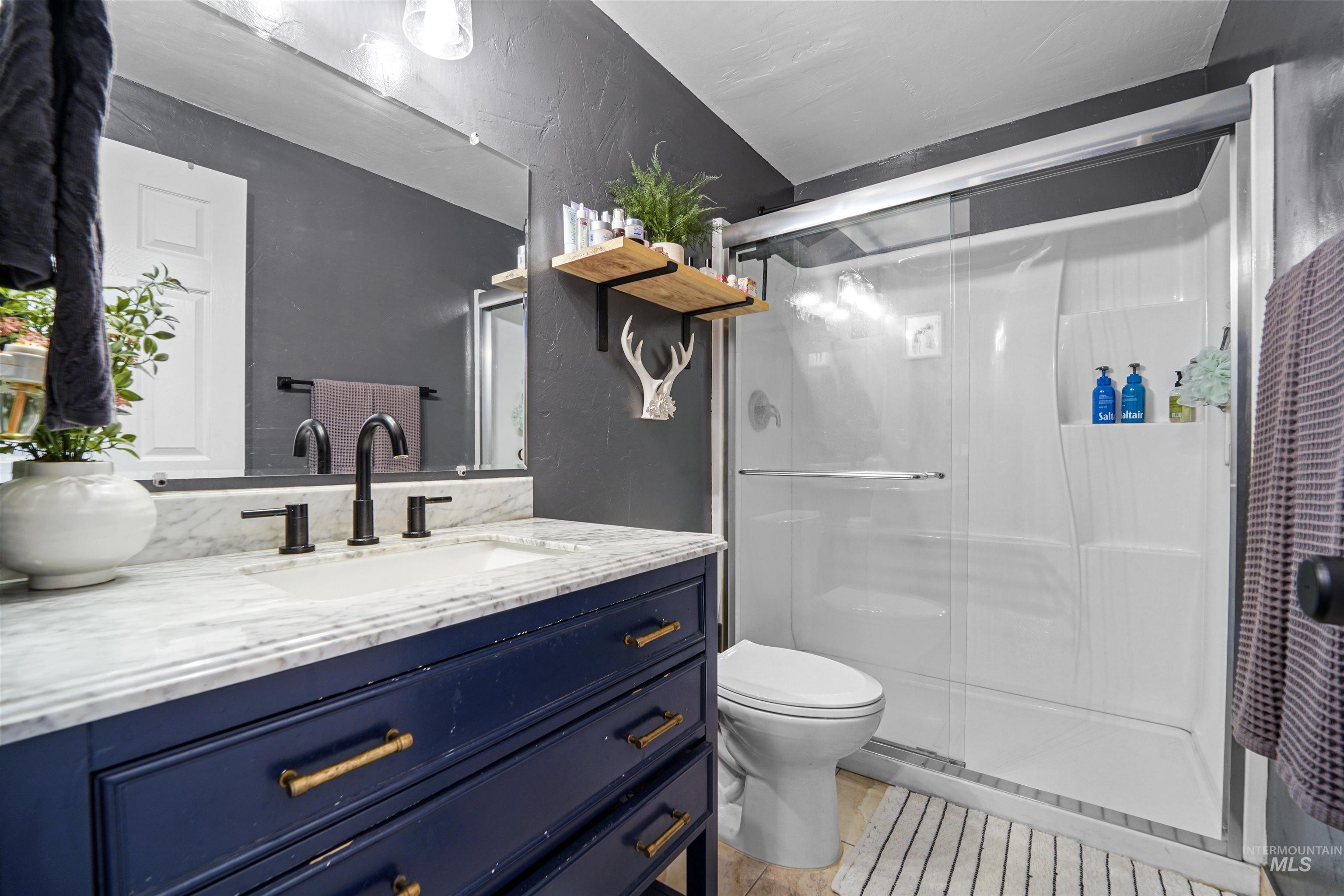 348 North Eagle Road Eagle, ID 83616 - Photo 14 of 31 Full bathroom with vanity, a stall shower, and tile patterned floors