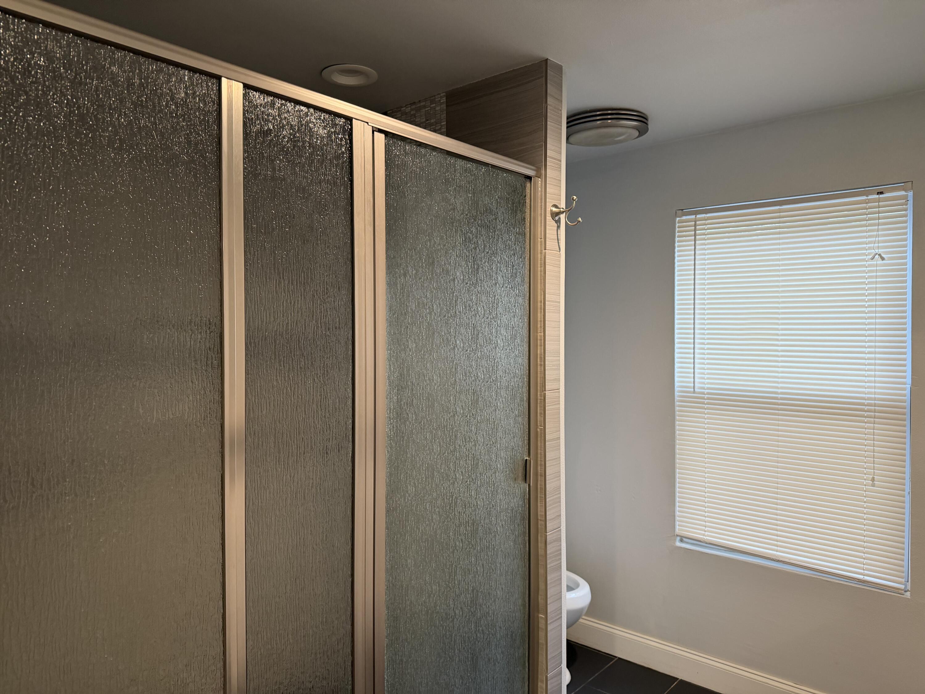 3110 22nd Street Lubbock, TX 79410 - Photo 13 of 22 a bathroom with a glass shower door