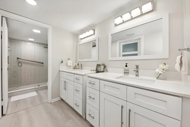 a bathroom with double sink and a mirror