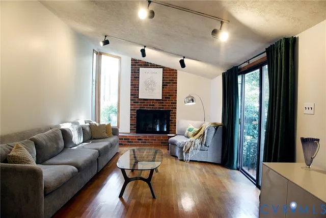 a living room with furniture and a fireplace