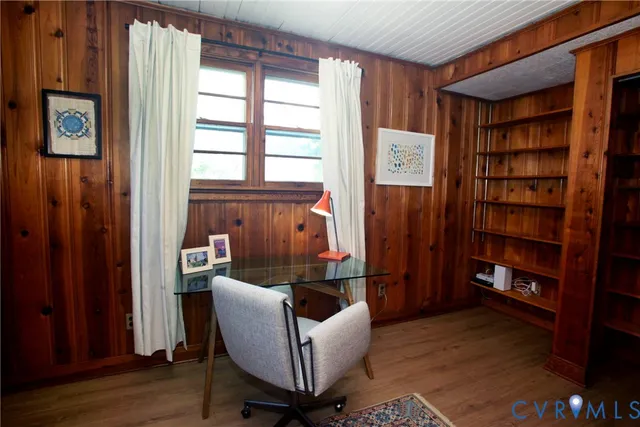a living room with furniture and a book shelf