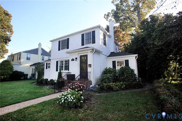 a front view of a house with trees