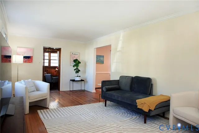 a living room with furniture and wooden floor