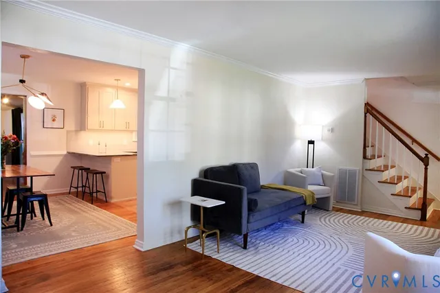 a living room with furniture and wooden floor