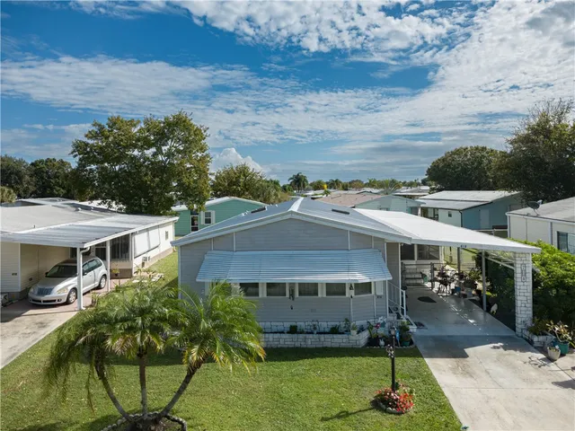 an aerial view of a house with a garden and plants