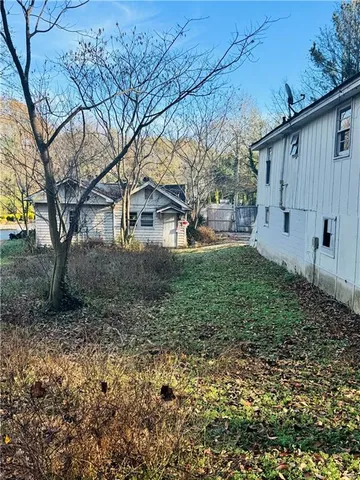 a backyard of a house with lots of green space