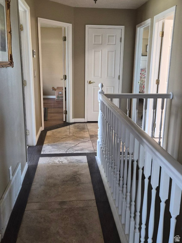 1697 West 2450 Vernal, UT 84078 - Photo 15 of 36 Hallway with baseboards and an upstairs landing