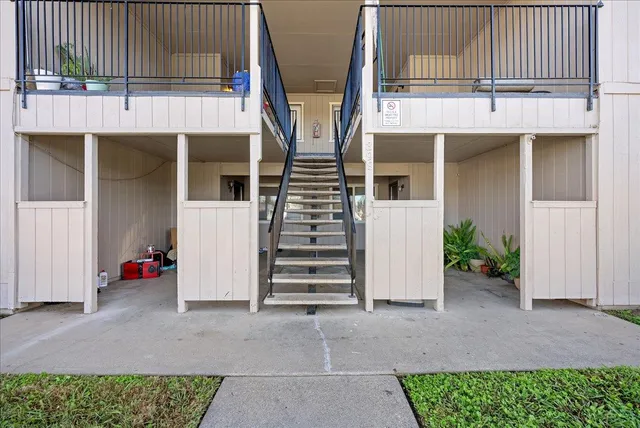 a view of a house with a yard and sitting area