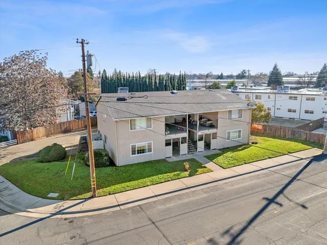 an aerial view of a house with a garden and lake view