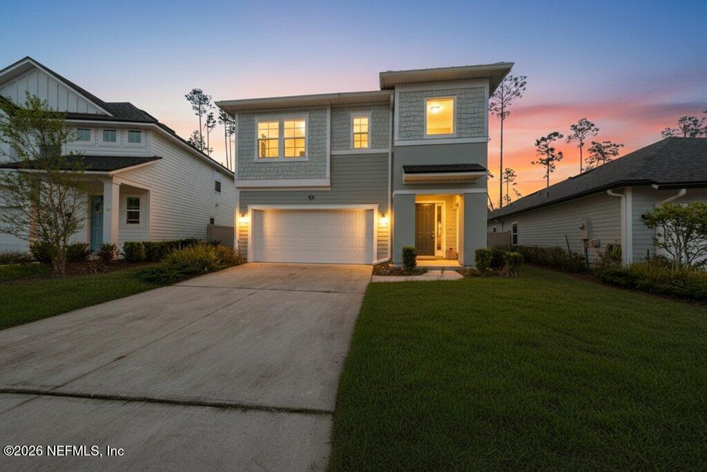 200 Starnberg Ct Street St. Augustine, FL 32095 - Photo 2 of 48 a front view of a house with a yard and outdoor seating