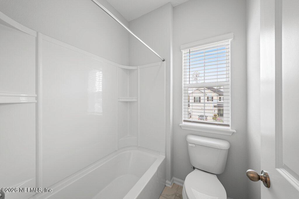 200 Starnberg Ct Street St. Augustine, FL 32095 - Photo 23 of 48 a white toilet sitting next to a bath tub