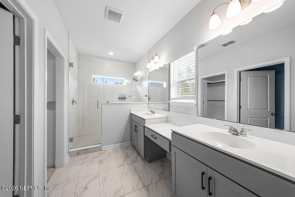 200 Starnberg Ct Street St. Augustine, FL 32095 - Photo 30 of 48 a bathroom with a sink double vanity granite tub shower and a mirror