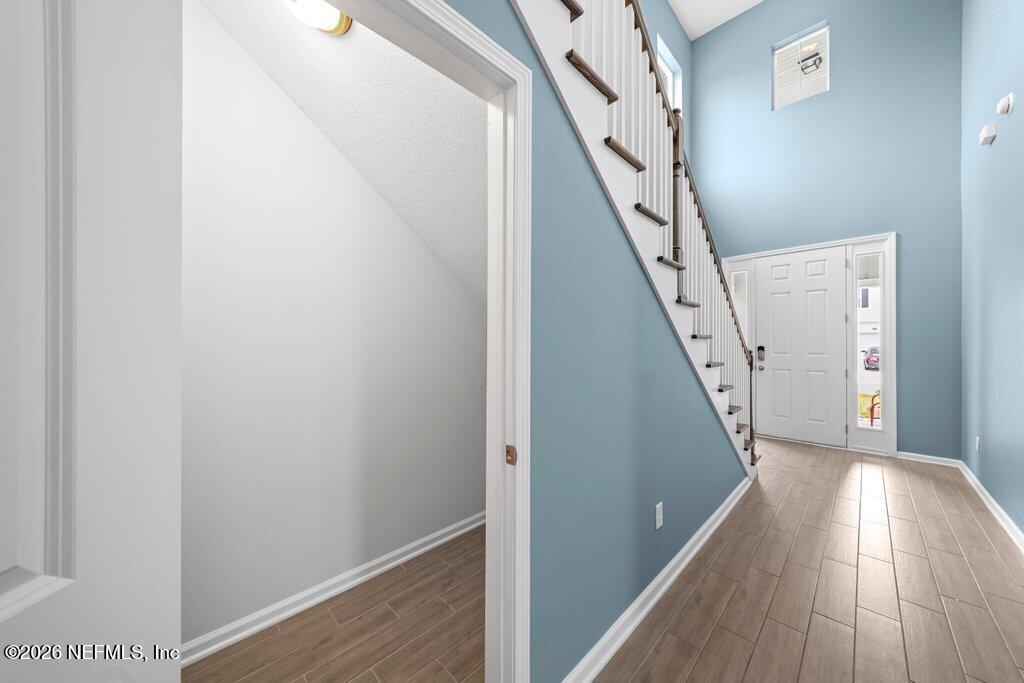 200 Starnberg Ct Street St. Augustine, FL 32095 - Photo 34 of 48 a view of a hallway with wooden floor and staircase