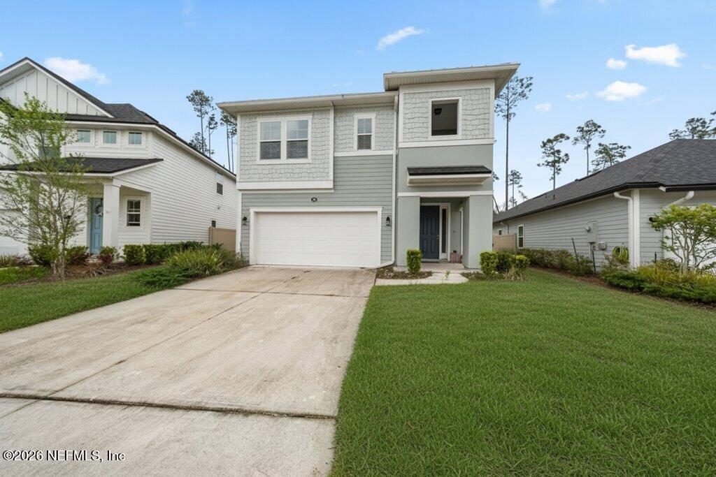 200 Starnberg Ct Street St. Augustine, FL 32095 - Photo 4 of 48 a front view of a house with a yard and garage
