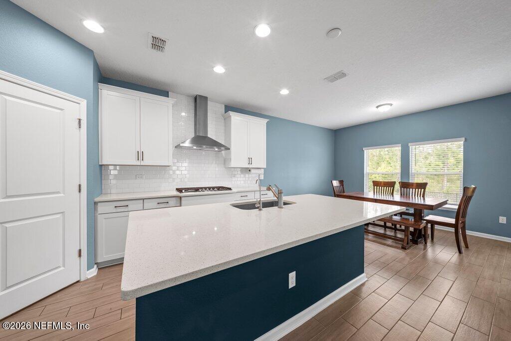 200 Starnberg Ct Street St. Augustine, FL 32095 - Photo 44 of 48 a kitchen with a sink a stove cabinets and wooden floor