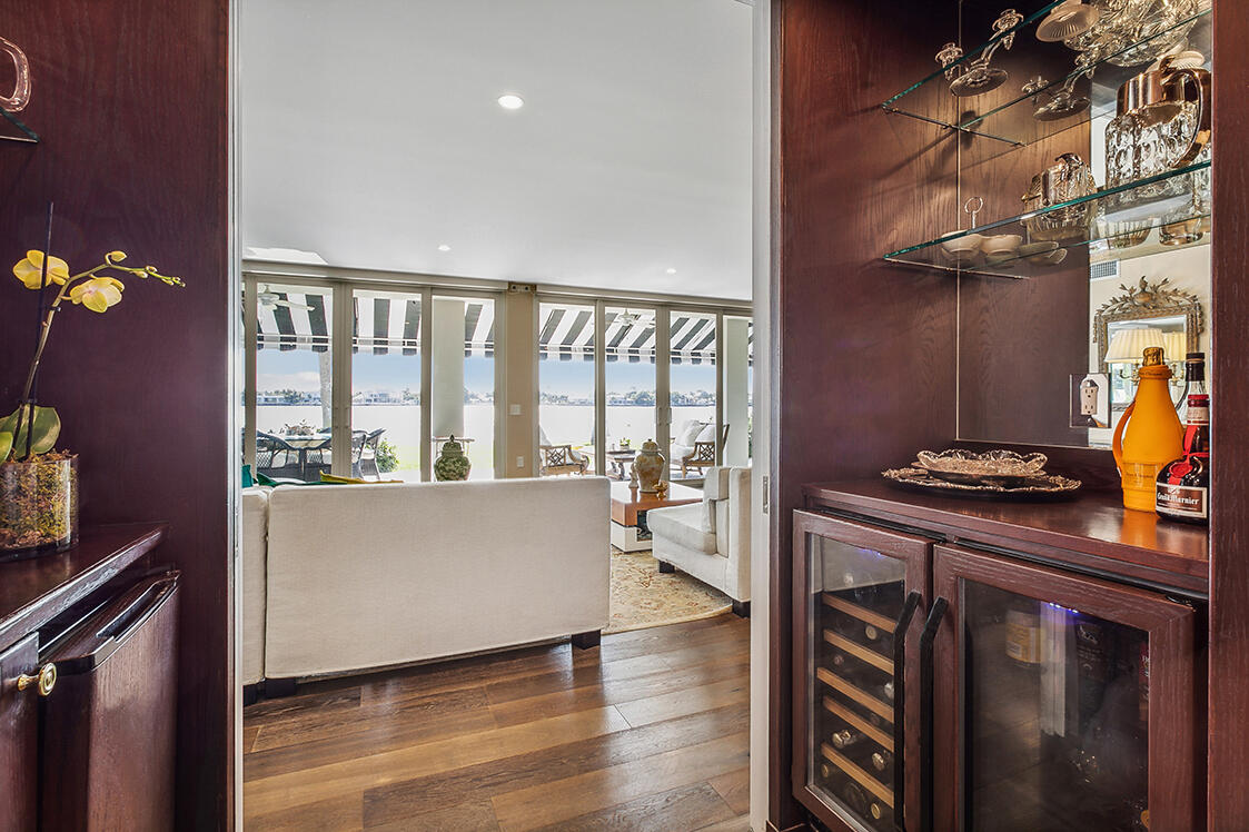 2160 Ibis Isle Road, Unit 1 Palm Beach, FL 33480 - Photo 16 of 44 a living room with furniture a flat screen tv and a floor to ceiling window
