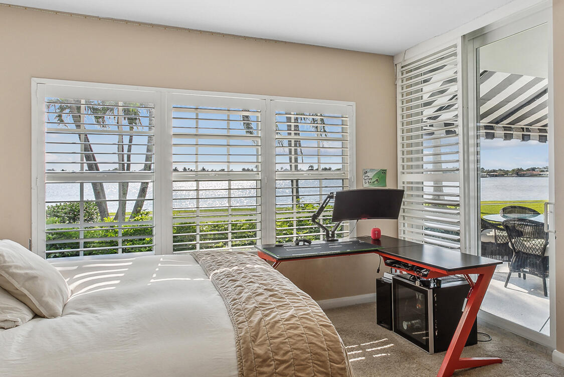2160 Ibis Isle Road, Unit 1 Palm Beach, FL 33480 - Photo 24 of 44 a bedroom with a bed and a large window