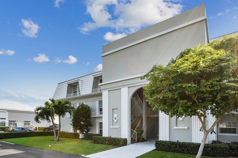 2160 Ibis Isle Road, Unit 1 Palm Beach, FL 33480 - Photo 34 of 44 a front view of a house with a yard and garage