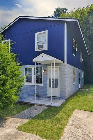 a front view of house with yard and outdoor seating