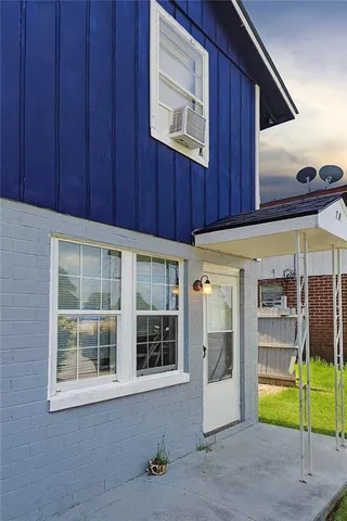 a view of a door and wooden floor in a room