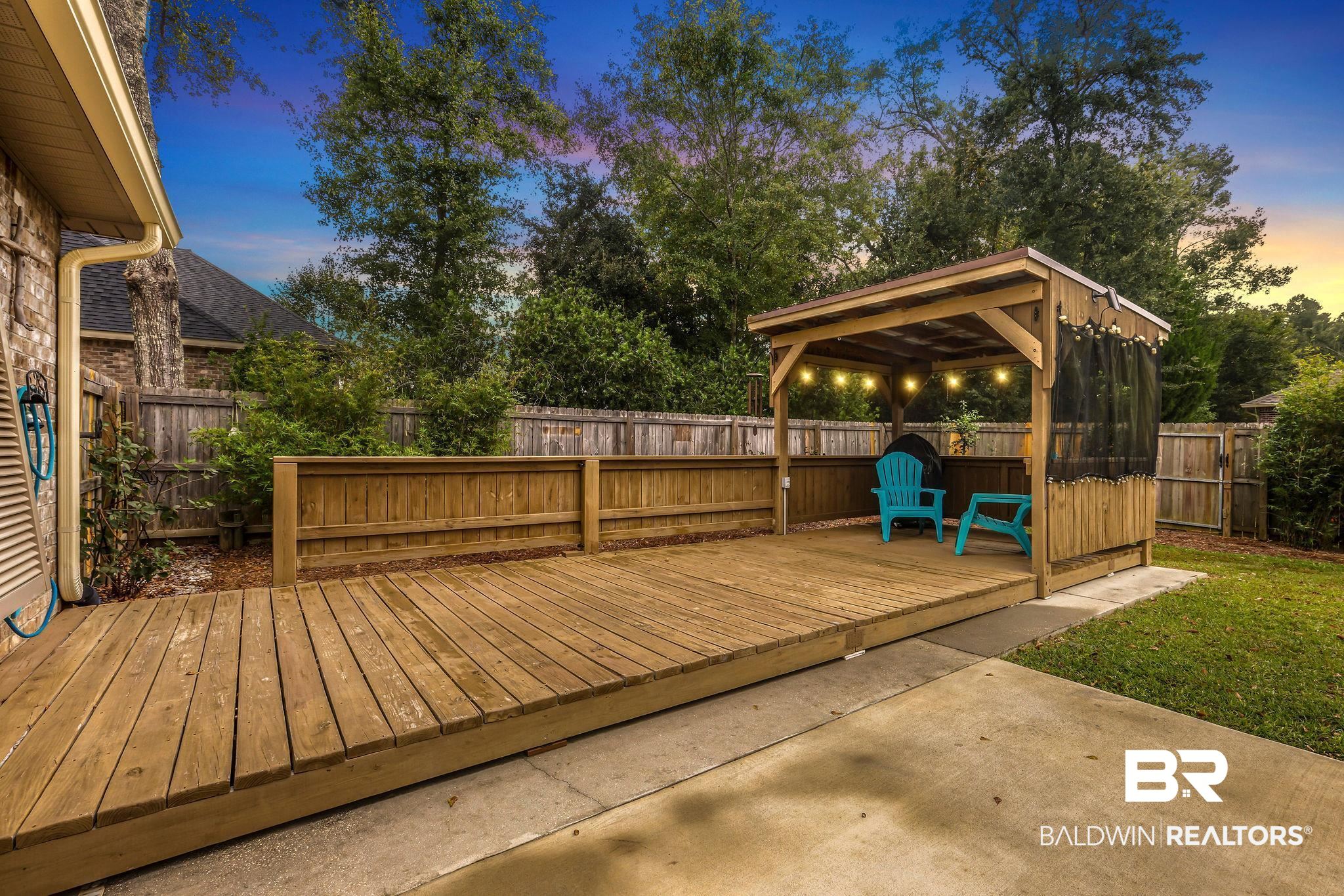 1086 Destin Avenue Foley, AL 36535 - Photo 30 of 30 Deck at dusk with a gazebo and a patio