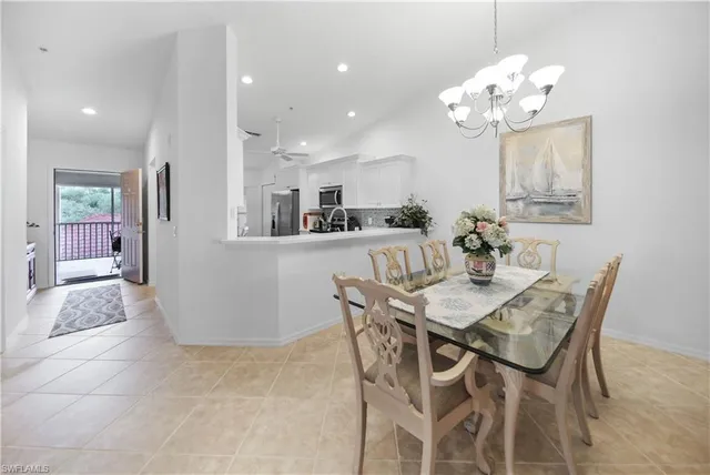 a view of a dining room with furniture and chandelier