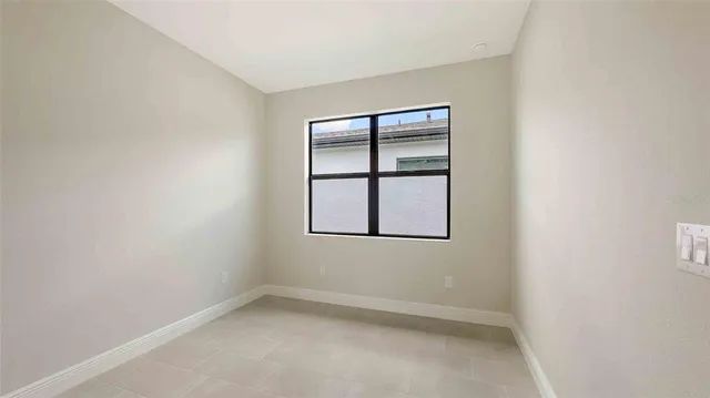 a bathroom with a granite countertop bathtub sink vanity mirror and toilet