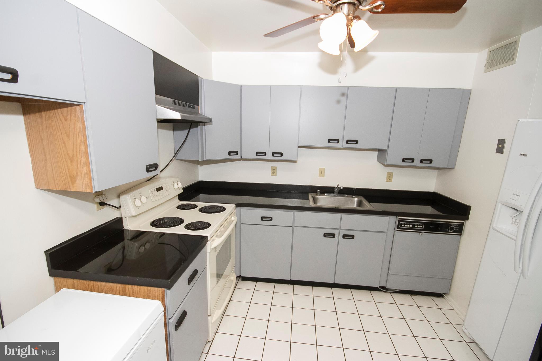 2901 Fallstaff Road, Unit 504 Baltimore, MD 21209 - Photo 11 of 22 a kitchen with a sink stove and cabinets