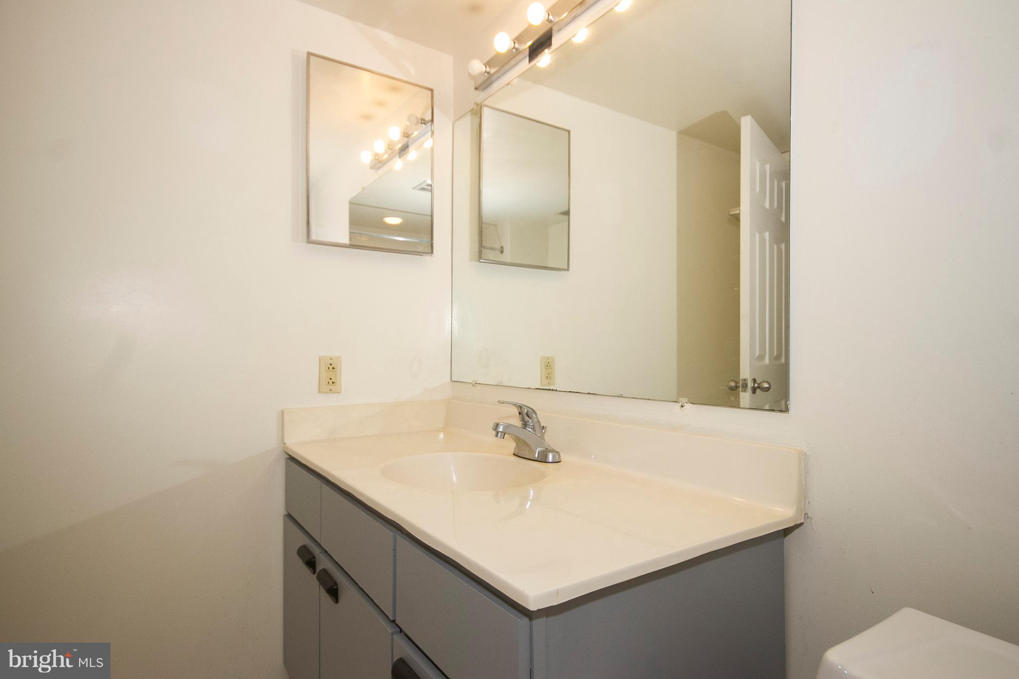 2901 Fallstaff Road, Unit 504 Baltimore, MD 21209 - Photo 14 of 22 a bathroom with a sink and a mirror