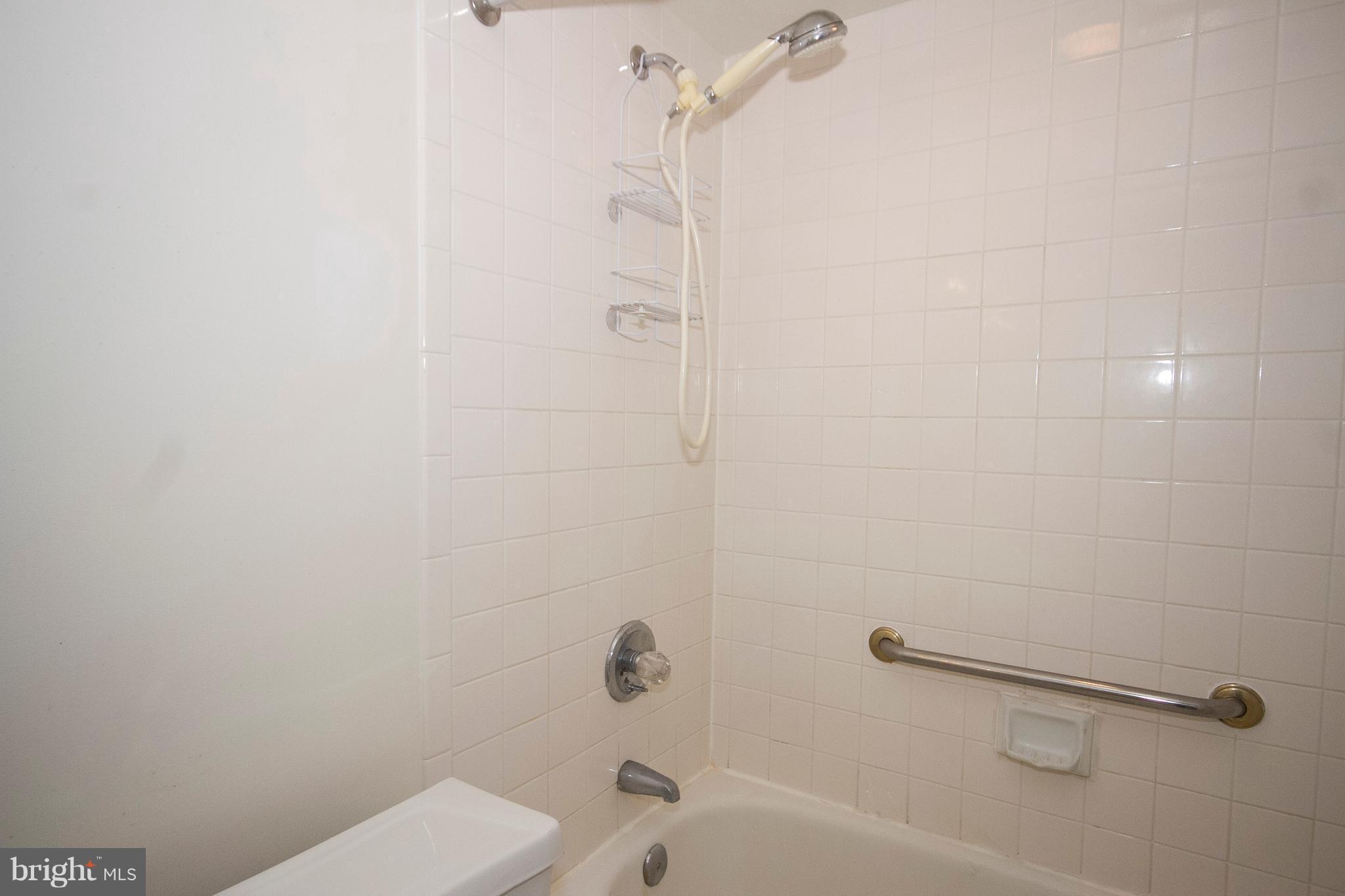 2901 Fallstaff Road, Unit 504 Baltimore, MD 21209 - Photo 15 of 22 a bathroom with a shower and a toilet