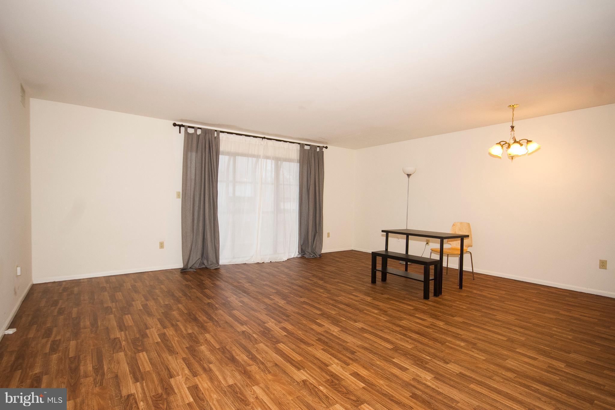 2901 Fallstaff Road, Unit 504 Baltimore, MD 21209 - Photo 4 of 22 a view of a room with a table and chairs