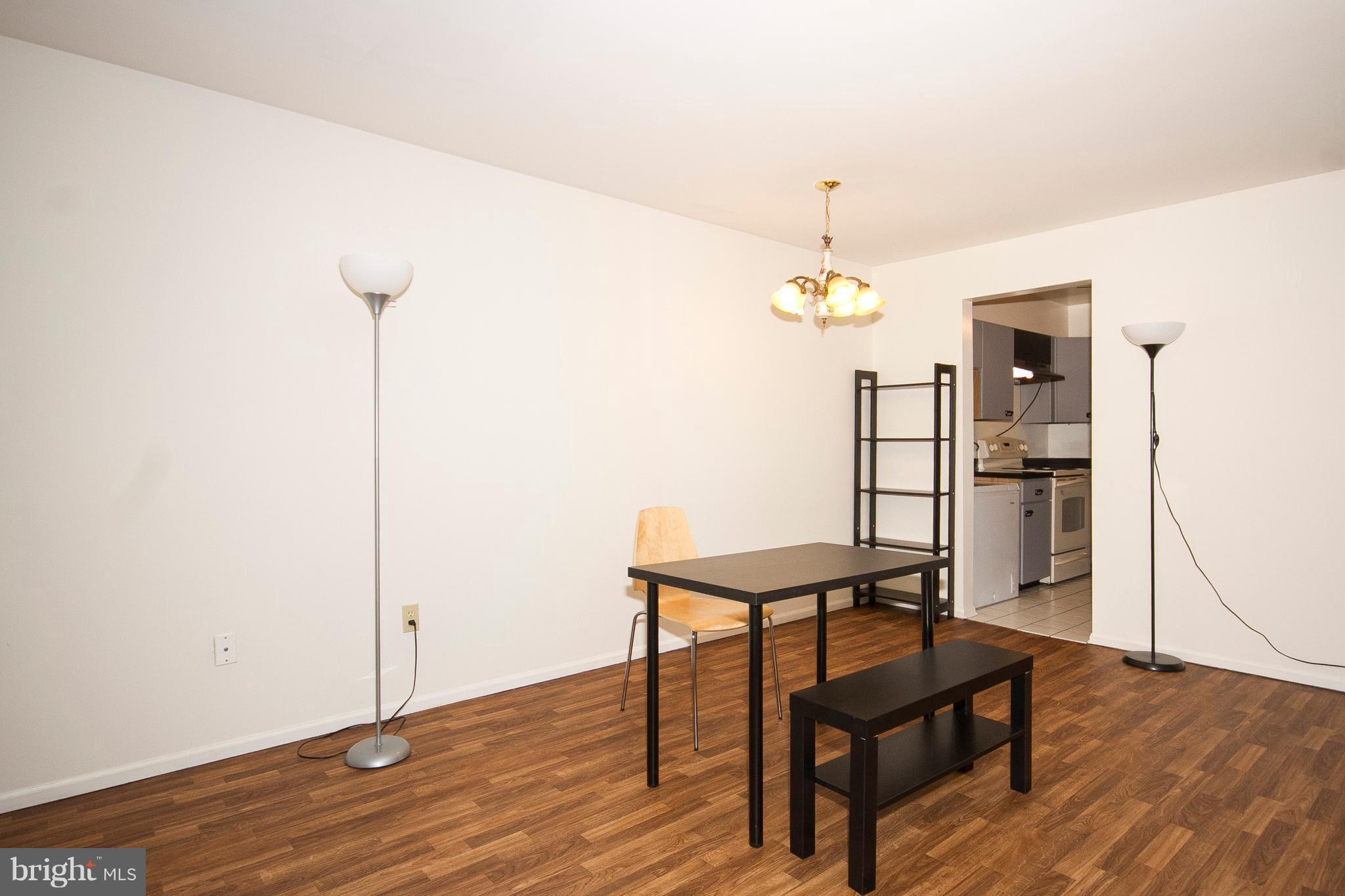 2901 Fallstaff Road, Unit 504 Baltimore, MD 21209 - Photo 7 of 22 a view of a hallway with wooden floor and a chandelier