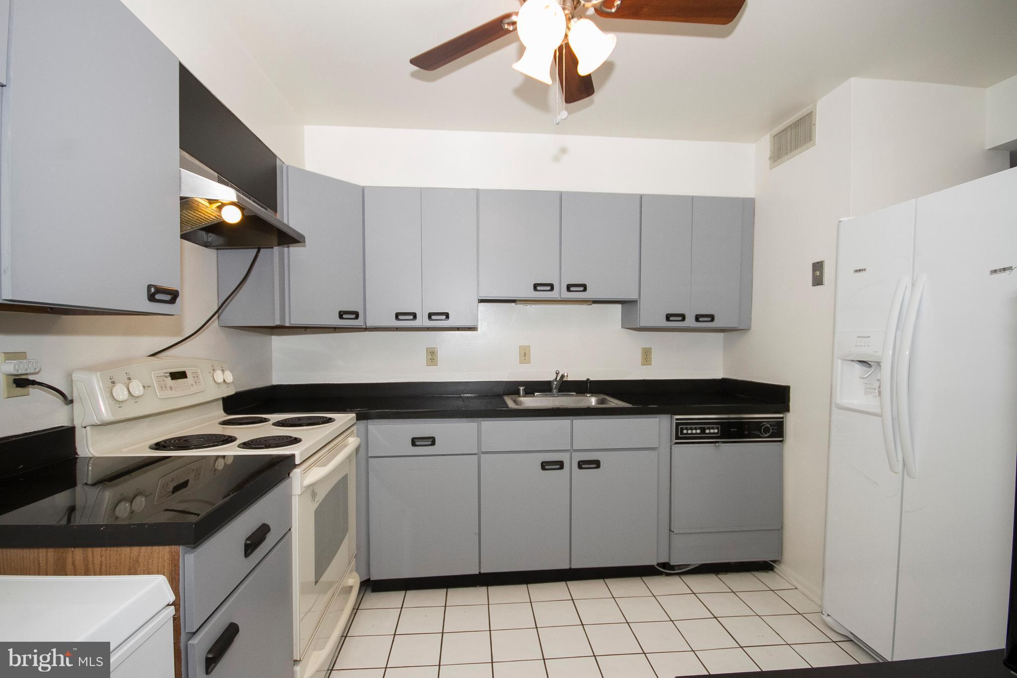 2901 Fallstaff Road, Unit 504 Baltimore, MD 21209 - Photo 8 of 22 a kitchen with stainless steel appliances a sink a stove a refrigerator and cabinets