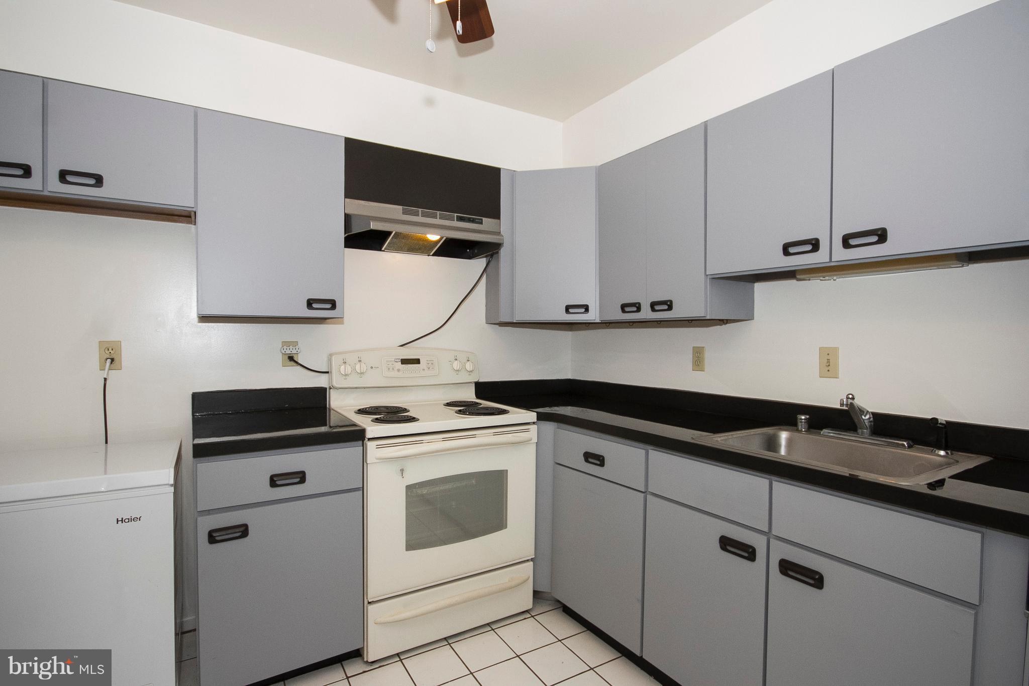 2901 Fallstaff Road, Unit 504 Baltimore, MD 21209 - Photo 9 of 22 a kitchen with cabinets appliances and a sink