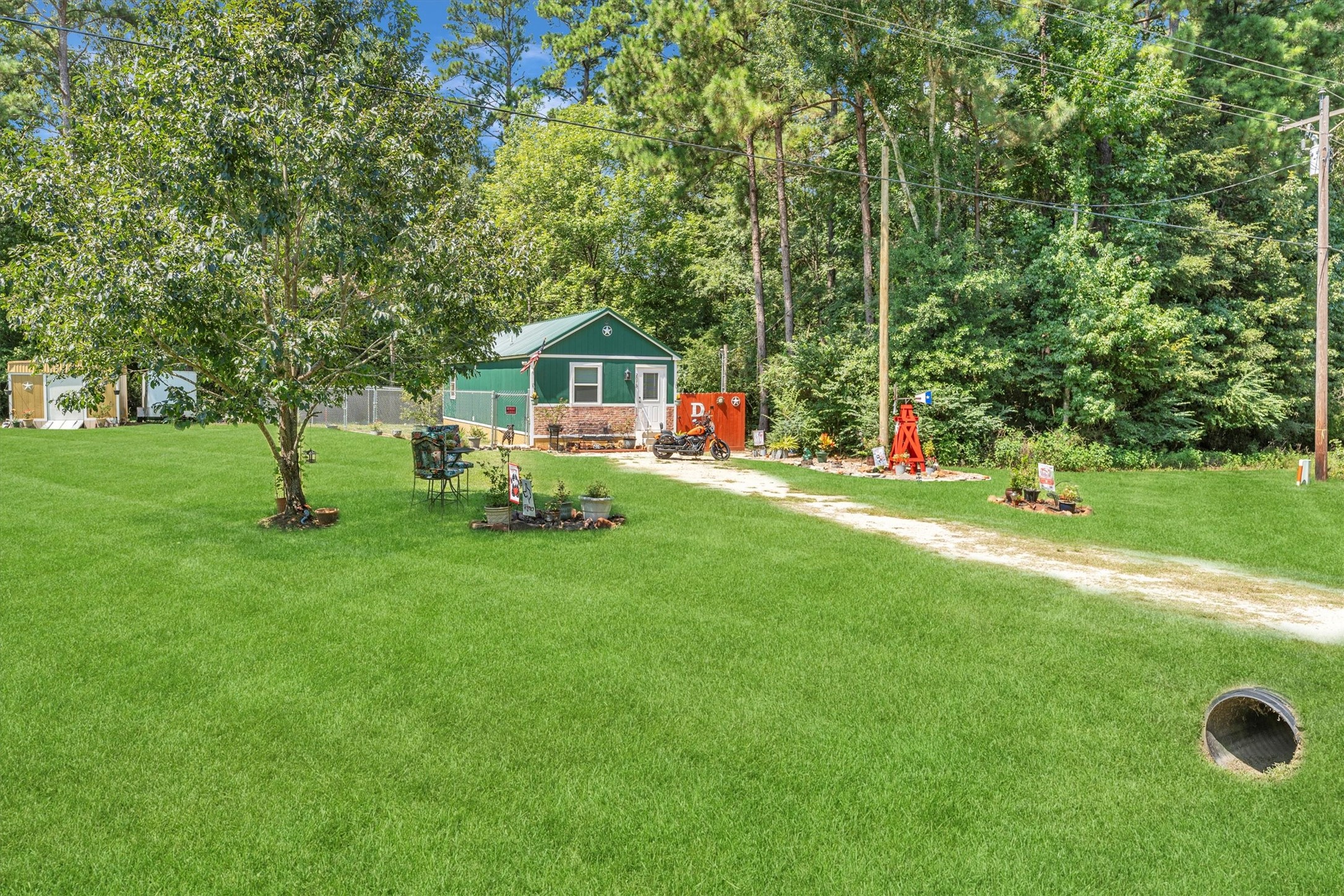 a view of a house with a backyard and tree