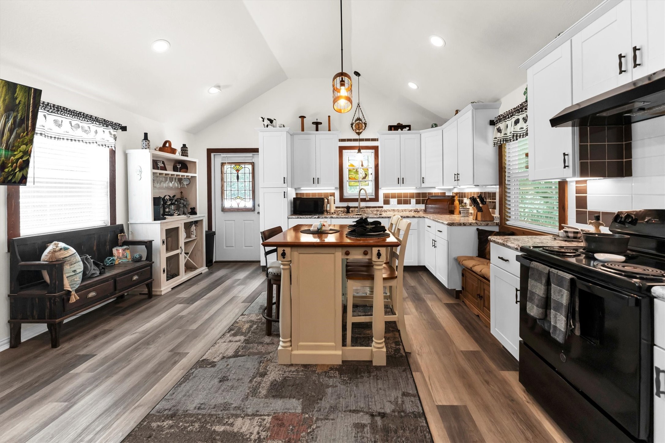 2075 Mangum Road Livingston, TX 77351 - Photo 12 of 45 a kitchen with stainless steel appliances granite countertop a stove top oven a sink dishwasher a dining table and chairs with wooden floor