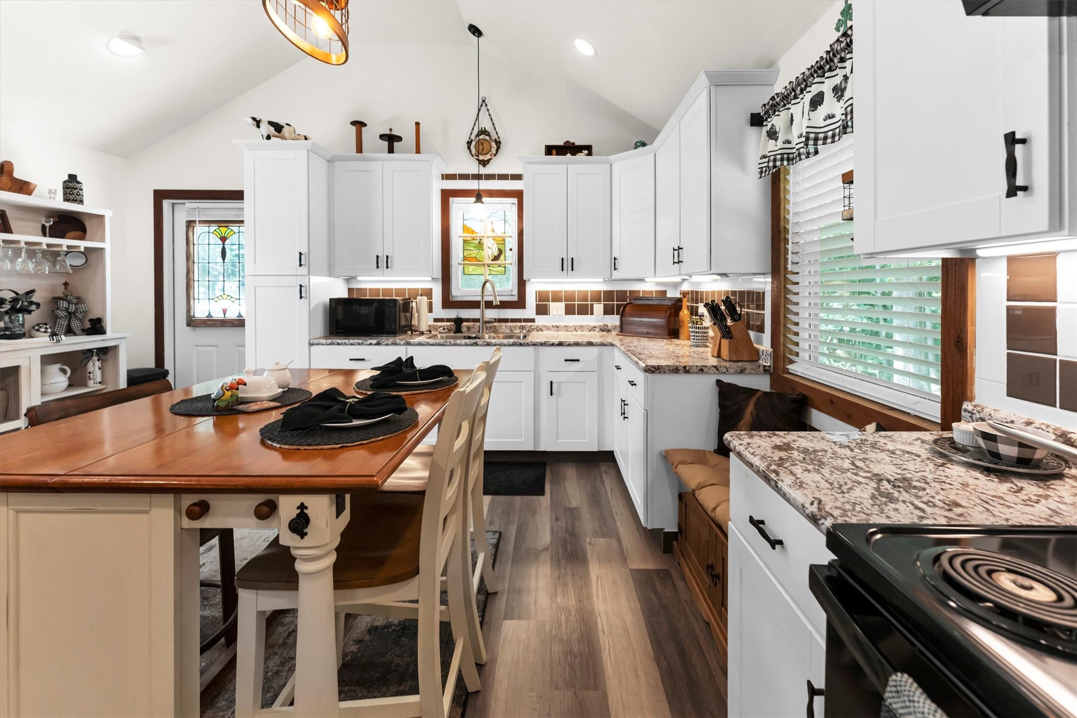2075 Mangum Road Livingston, TX 77351 - Photo 15 of 45 a kitchen with a stove a sink dishwasher a dining table and chairs with wooden floor