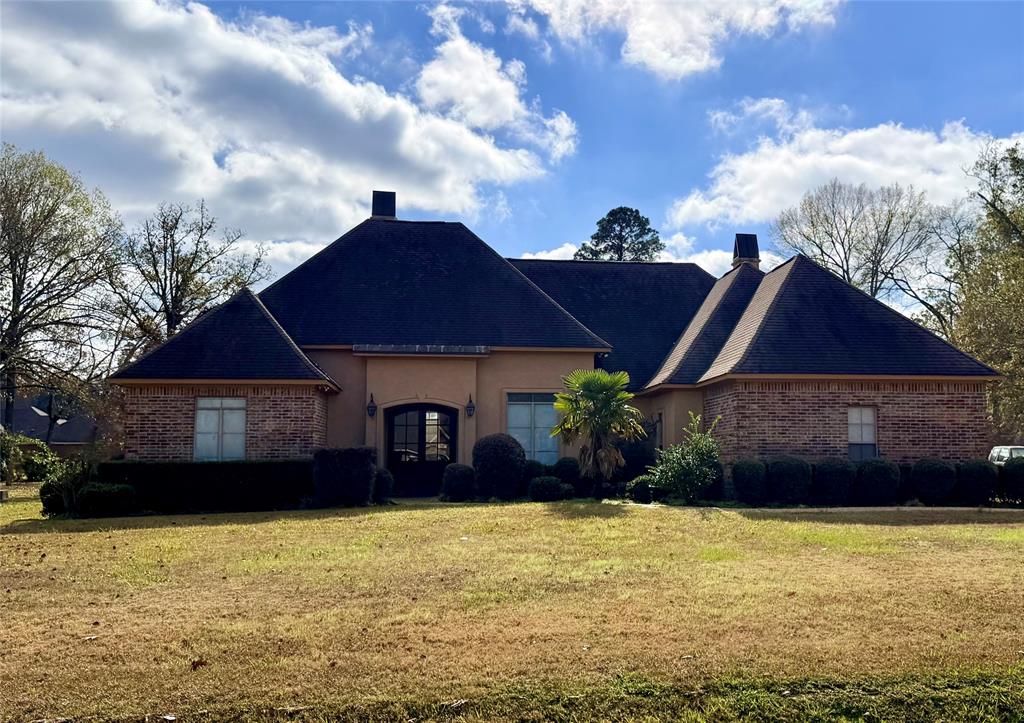 a front view of a house with a garden