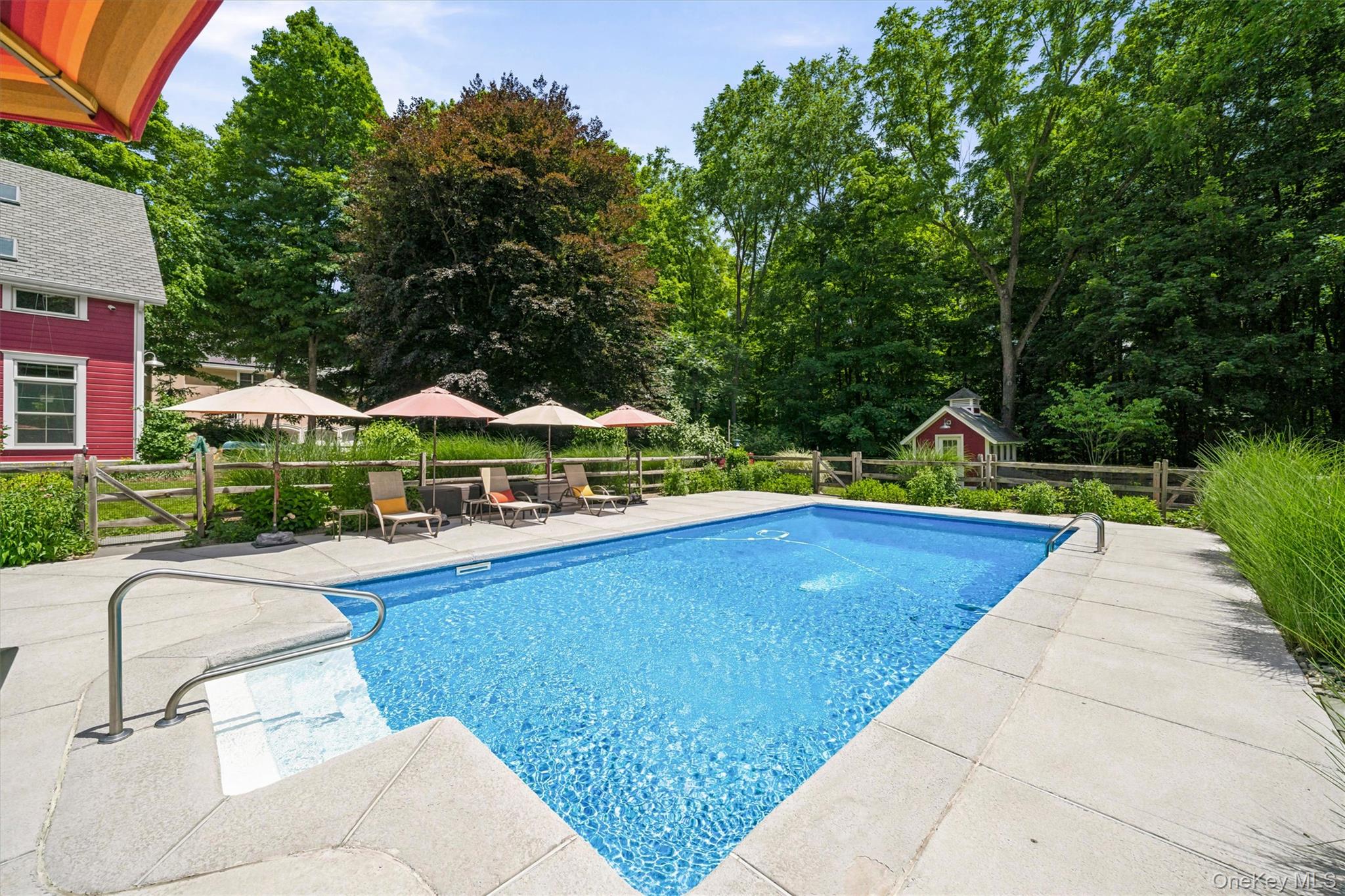 324 Haverstraw Road Suffern, NY 10901 - Photo 33 of 50 a view of swimming pool with lounge chair and trees in the background