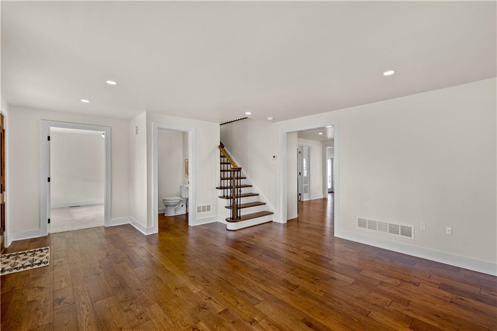 411 Georgetown Road Lawrence, PA 15055 - Photo 15 of 40 a view of an empty room with wooden floor and stairs