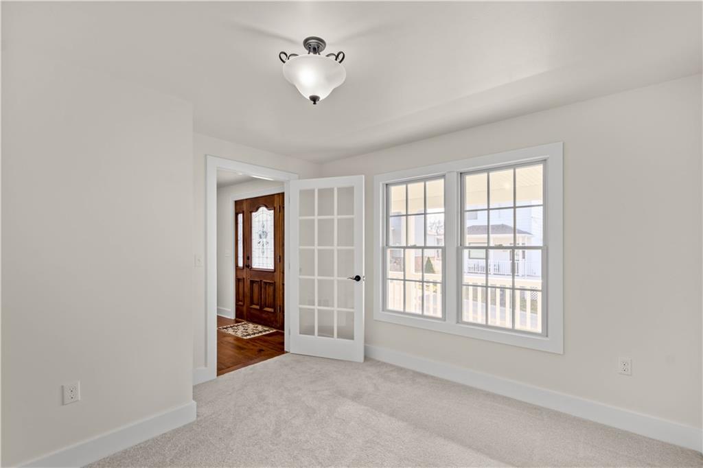 411 Georgetown Road Lawrence, PA 15055 - Photo 25 of 40 an empty room with chandelier fan and windows