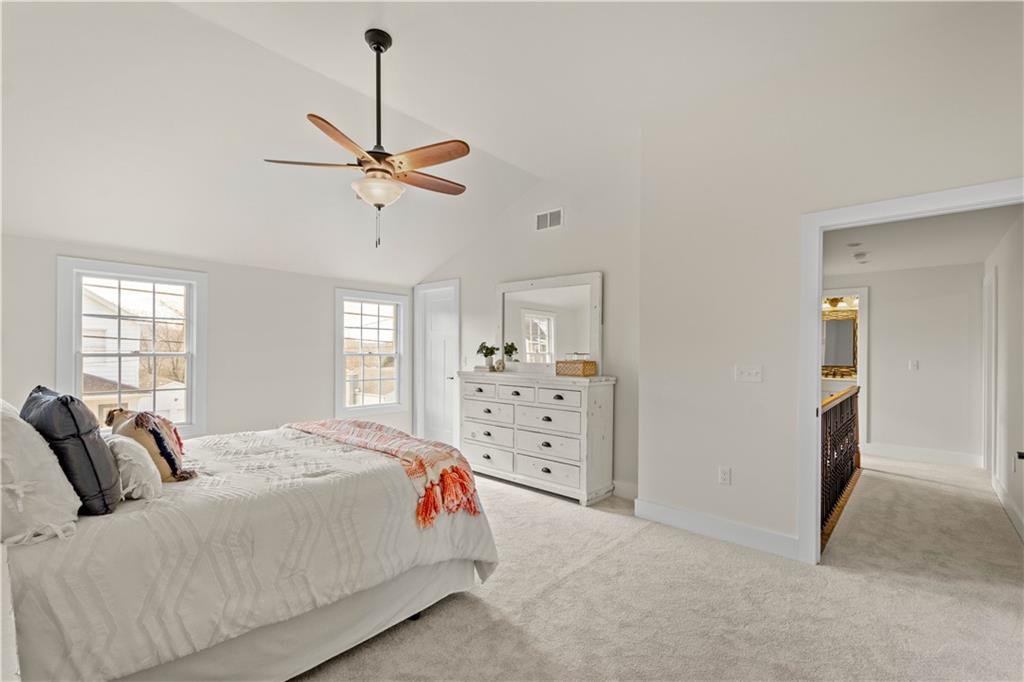 411 Georgetown Road Lawrence, PA 15055 - Photo 35 of 40 a bedroom with a bed a window and a chandelier