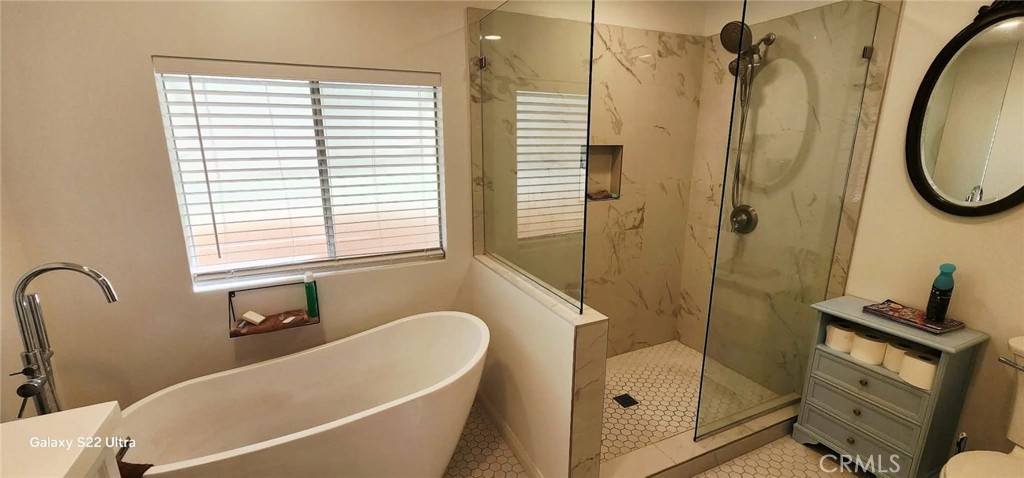 8651 Foothill Boulevard, Unit 159 Rancho Cucamonga, CA 91730 - Photo 15 of 18 a bathroom with a tub a sink and a window